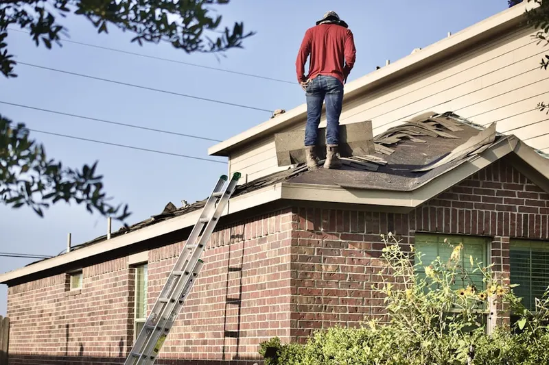 Professional roofer working on a residential roof in Janesville